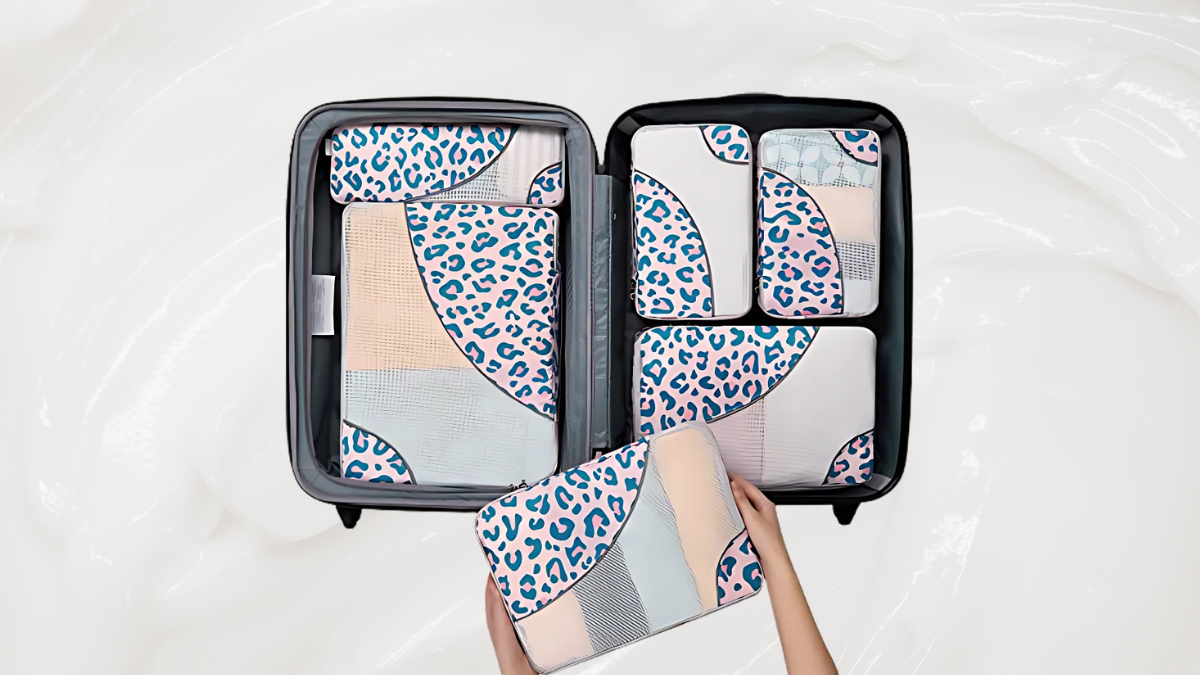 A vibrant set of packing cubes with pastel leopard and geometric designs, neatly organized inside an open suitcase. The playful patterns bring a touch of style and functionality to travel essentials.