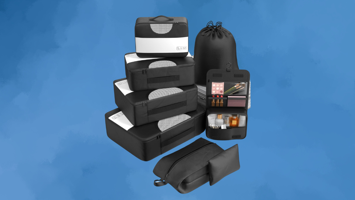 A sleek black travel packing set featuring multiple organizers, including mesh-topped packing cubes, a drawstring laundry bag, a toiletry kit with compartments, and a slim zippered pouch.