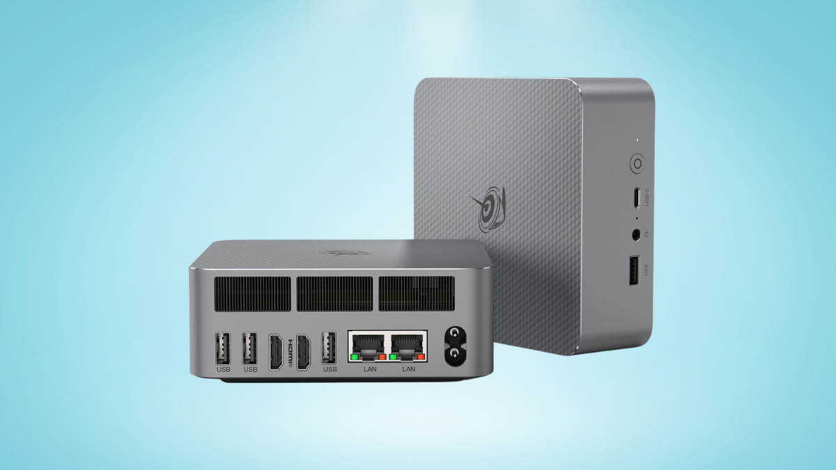 Compact gray mini PC showcasing multiple connectivity ports on a clean light blue background.