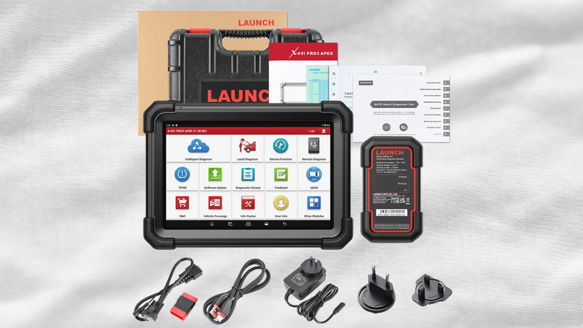 A diagnostic tablet tool with accessories, including cables, adapters, and a protective case, displayed on a textured background.