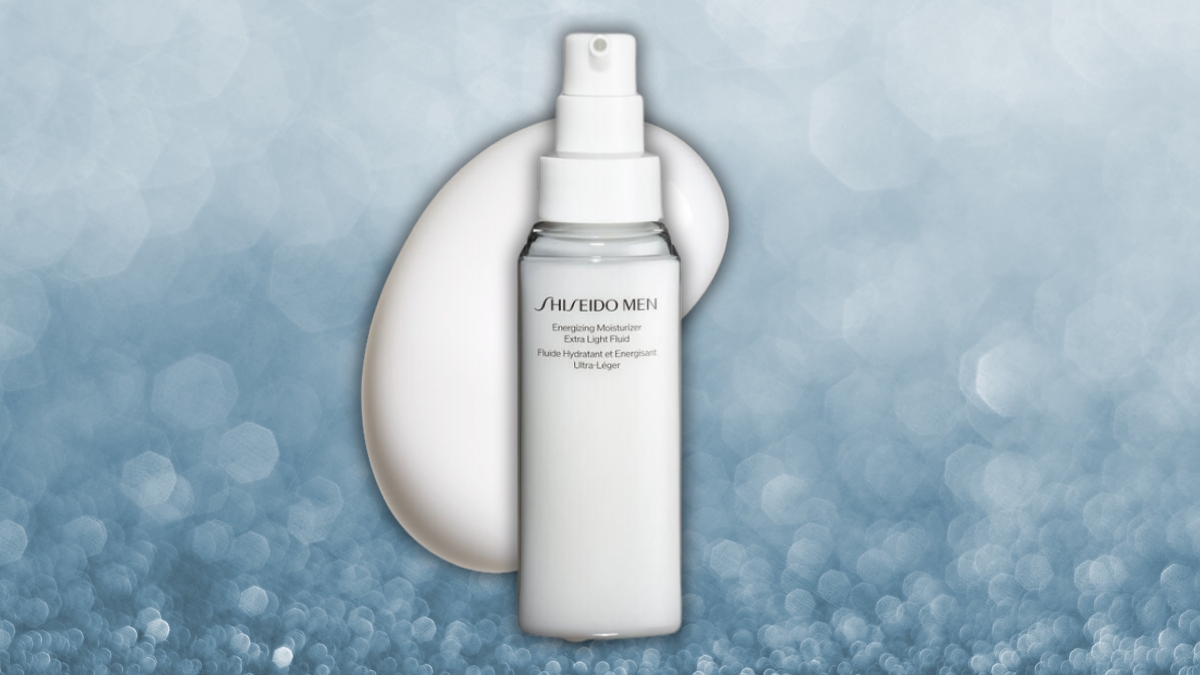 A bottle of Shiseido moisturizer is displayed against a soft blue background, with a creamy texture behind it.
