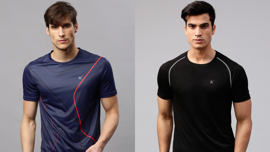 Two male models wearing fitted athletic t-shirts, one in navy blue with red lines and the other in solid black with gray trim.