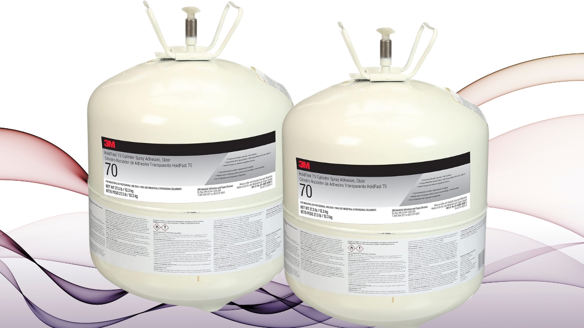 Two white 3M HoldFast 70 Spray Adhesive cylinders with black and red labels are shown side by side, designed for industrial and construction use.