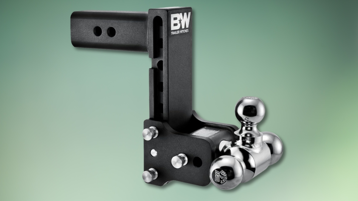 B&W Tow & Stow adjustable trailer hitch ball mount with tri-ball design shown on a green background.