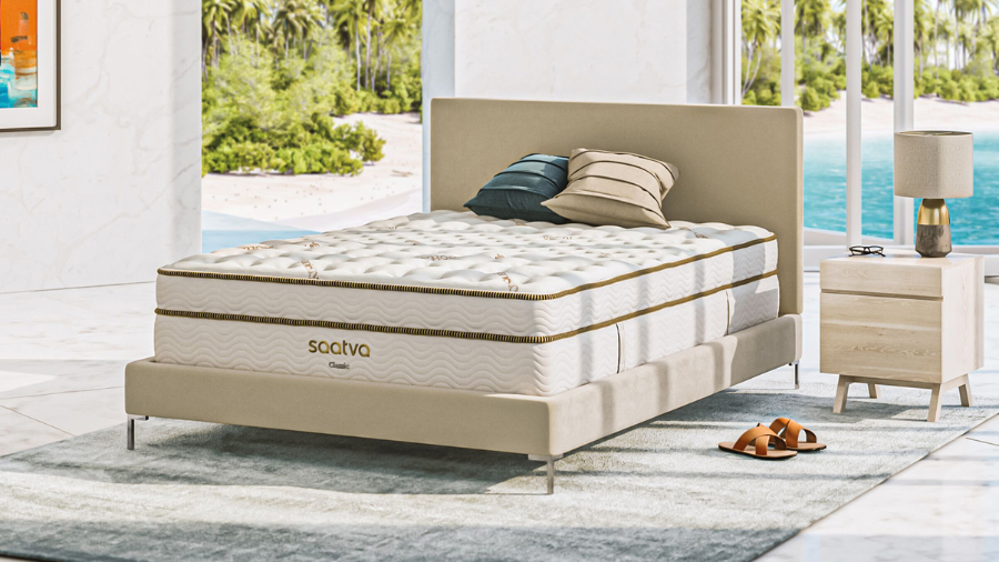 A Saatva Classic mattress in a bright, beachside bedroom setting.