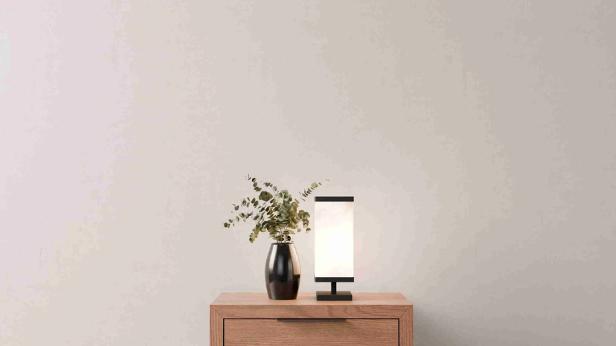 Modern bedroom with dark platform bed, gray bedding, and symmetrical black nightstands.