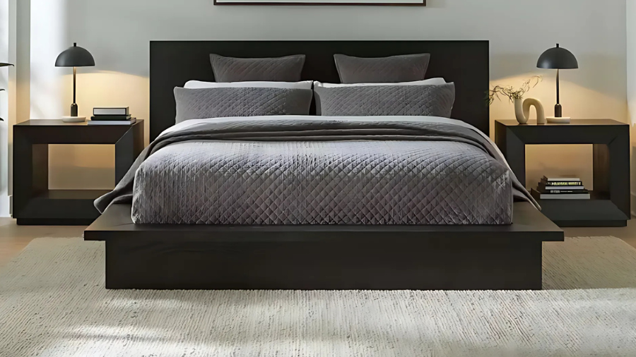 Modern bedroom with dark platform bed, gray bedding, and symmetrical black nightstands.