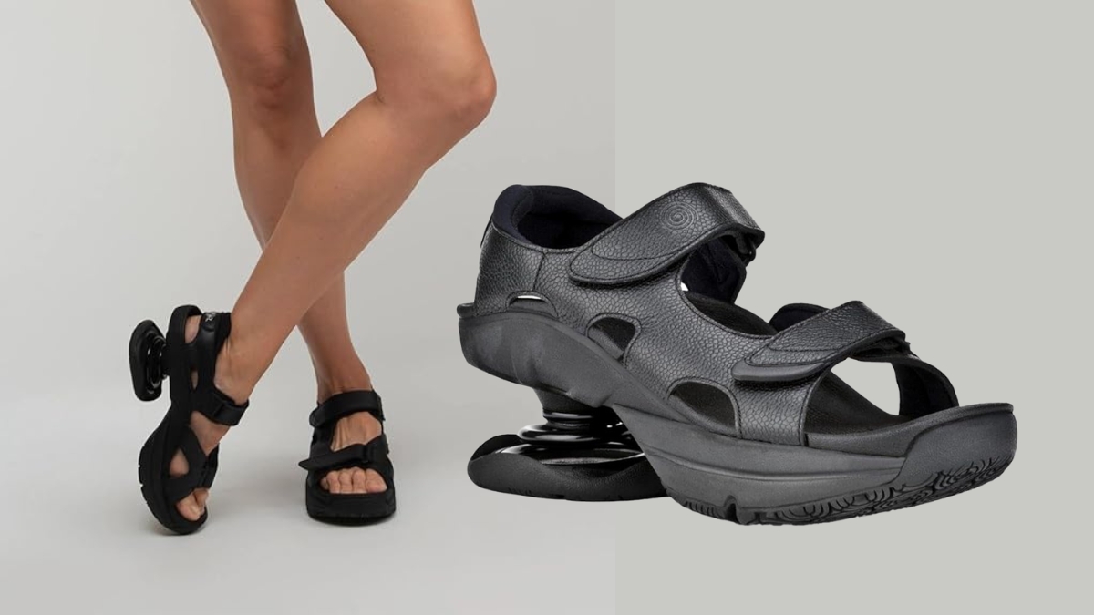 A woman wearing black Z-CoiL orthopedic sandals with visible spring heels for added foot and joint support.