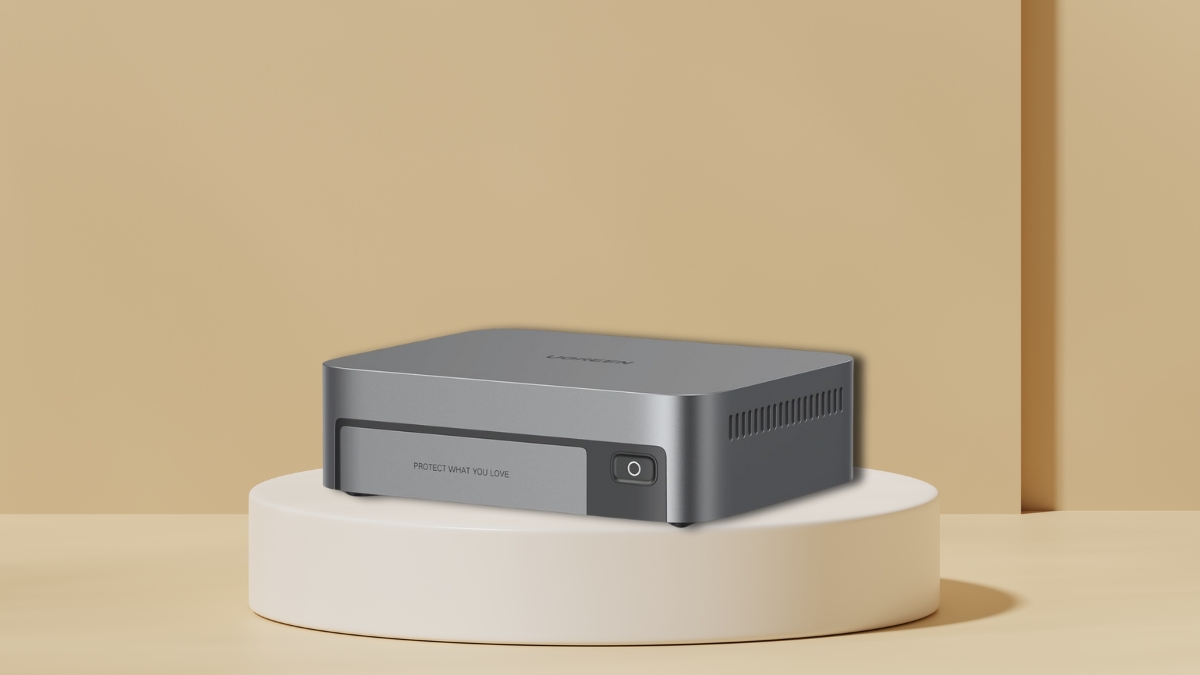 Compact UGREEN 4-bay SSD NAS device in gray with side vents and a front power button.