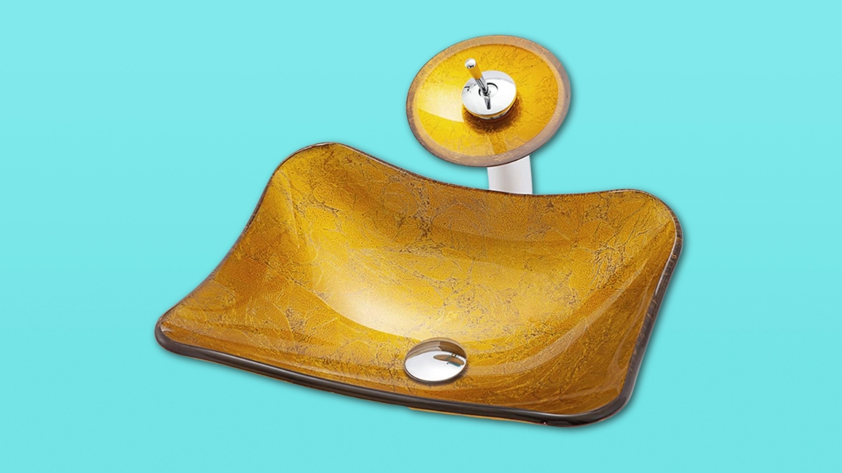 Golden yellow vessel sink with a matching glass waterfall faucet on a bright blue background.